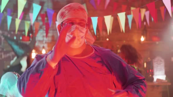 Adult Male in Crazy Surgeon Halloween Costume Dancing at a Party