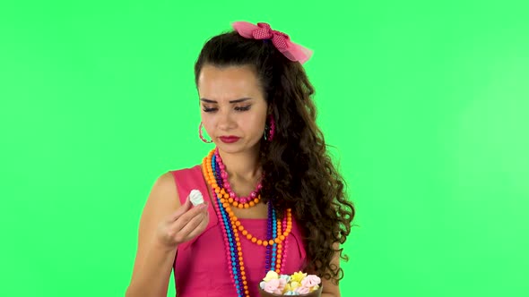 Beautiful Woman with Pleasure Eating Sweet White Marshmallow, It's Not Tasty. Green Screen