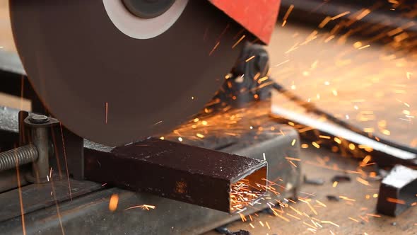 Worker cutting metal and spark with cutting machine