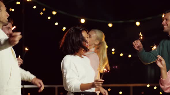 Friends with Sparklers Dancing at Rooftop Party 64