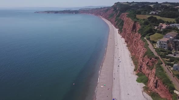 Aerial high to low, view of red cliffs that stretch along the coast, STATIC CROP