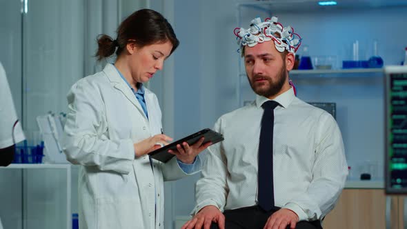 Man with Brainwave Scanning Headset Visiting Professional Doctor