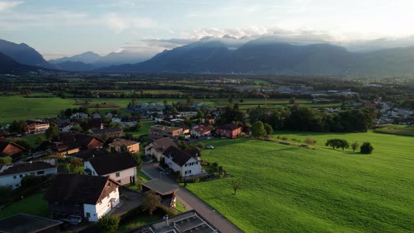 Aerial View of Liechtenstein with Houses on Green Fields in Alps Mountain Valley