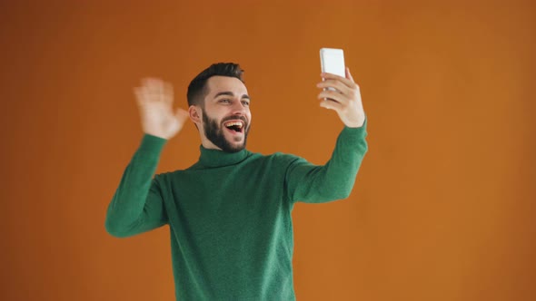 Portrait of Handsome Bearded Guy Taking Selfie with Smartphone Camera Having Fun