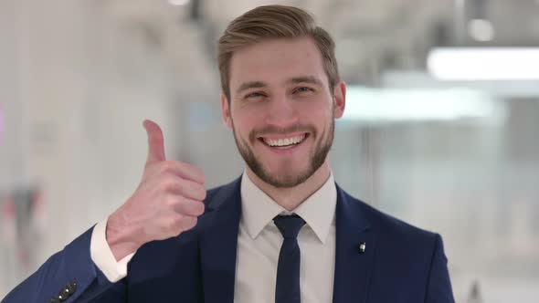 Young Businessman Showing Thumbs Up Sign