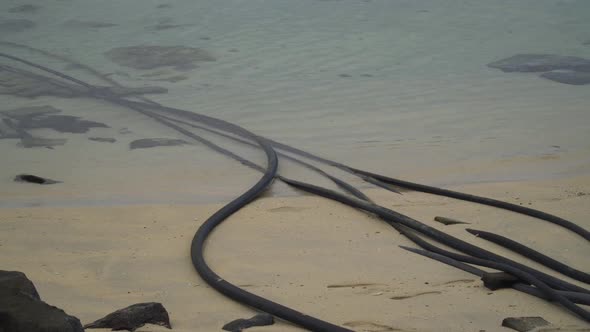 Desalination intake and outtake pipes going into warm water of an island in Fiji