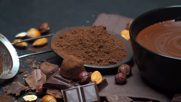 Ceramic Bowl of Chocolate Cream or Melted Chocolate, Nuts and Pieces of Chocolate