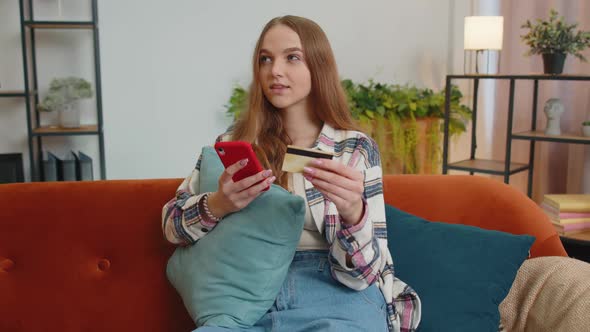 Woman Sitting at Home Using Credit Bank Card and Smartphone While Transferring Money Online Shopping