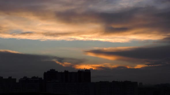 Time Lapse of Cloudy Sunset with City in the Background