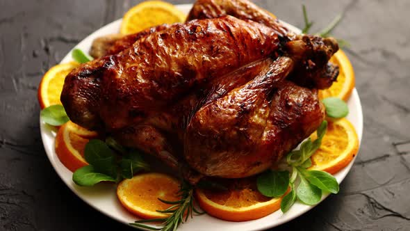 Roasted Whole Chicken or Turkey Served in White Ceramic Plate with Oranges