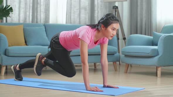 Fitness Asian Female Is Doing Mountain Climber Exercises In Her Home