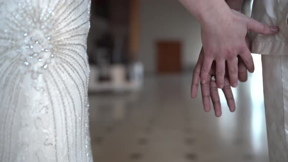 Bridal couple holding hands on their wedding day