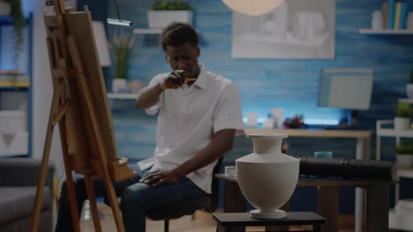 Black Young Man Drawing Vase for Creative Project