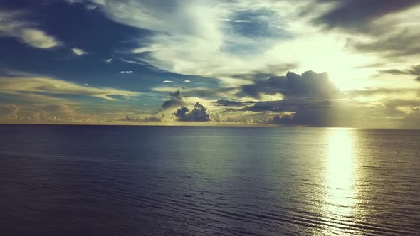 Ocean footage flying from the beach during a sunrise.