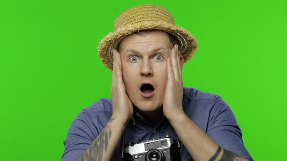 Portrait of Young Man Tourist Photographer Looking Shocked. Chroma Key