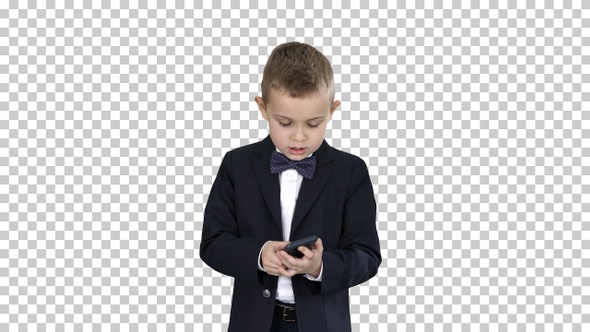 Small boy in costume walking and using smartphone, Alpha Channel