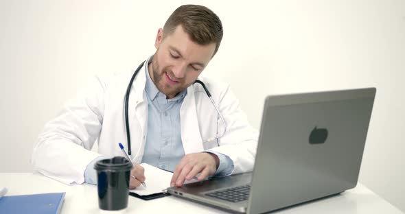 Male Doctor Work with Laptop at Office