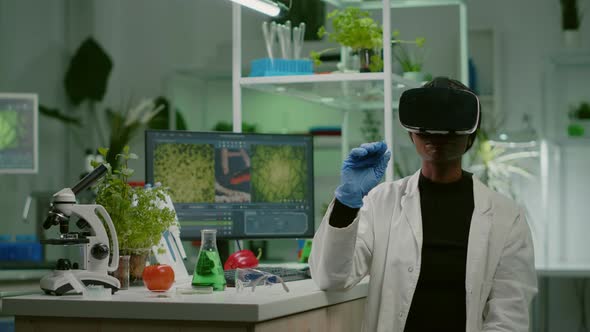 African Biologist Researcher with Virtual Reality Headset Researching New Genetic Experiment