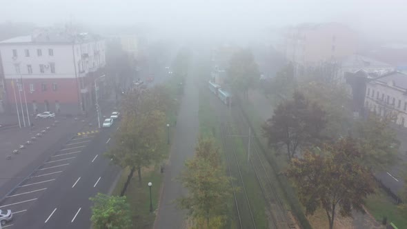 Foggy City Street with Silhouettes of Residential Buildings