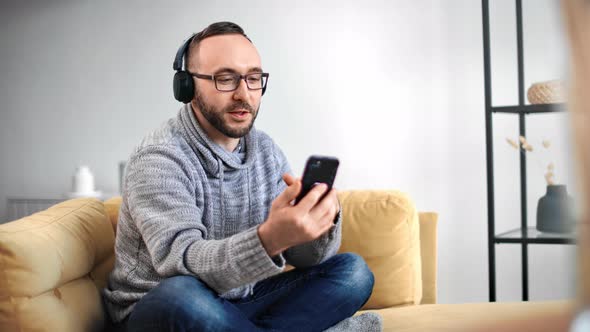 Casual Guy in Headphones Smiling Talking Online Video Call Smartphone