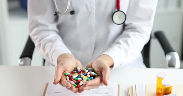 Doctor Holds Multicolored Medical Pills in Hands