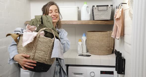 Portrait of a Happy Young Housewife with Clean Clothes