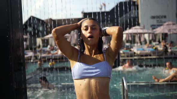 Beautiful Girl In Swimwear Showering Under Water At Resort Beach