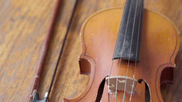 Antique Retro Classical Violin First Size on a Wooden Table