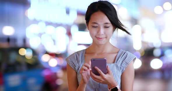 Woman Use of Mobile Phone for Mobile App at Night