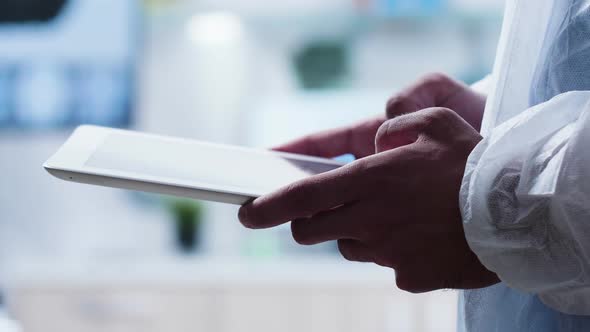 Close-up Shot of Researcher Using a Digital Tablet PC