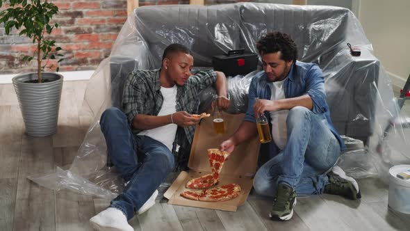 AfricanAmerican Brothers with Beer Bottles Eat Fresh Pizza