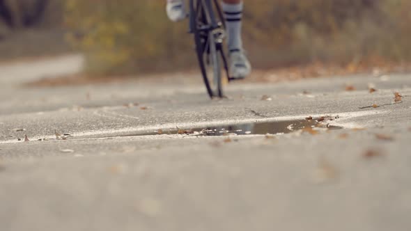 Cyclist Training Leisure Twists Pedals On Triathlon Bicycle. Gear System  And Bike Wheel.