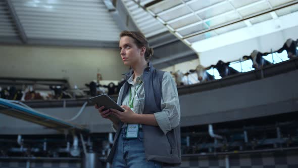 Focused Worker Dairy Farm Inspect Milking Parlour