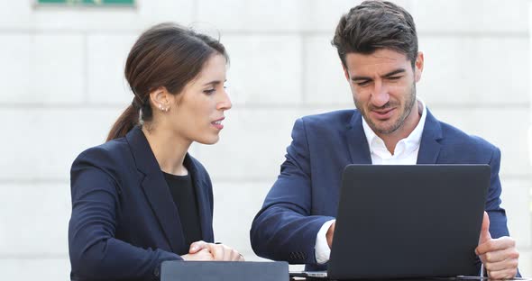 Business people discuss on laptop computer