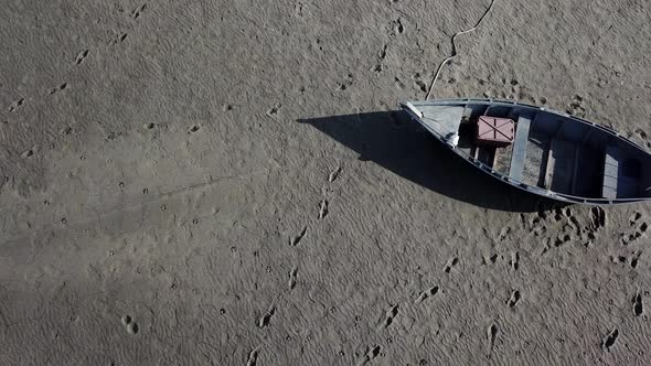 Top View of Boat at the Shore of Dried Up Sea Global Warming and Drought Concept