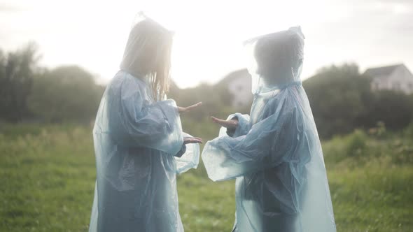 Side View of Happy Children Playing Rockpaperscissors in Sunrays on Rainy Summer Day