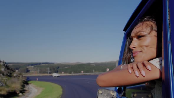 Young woman on a road trip in pick-up truck