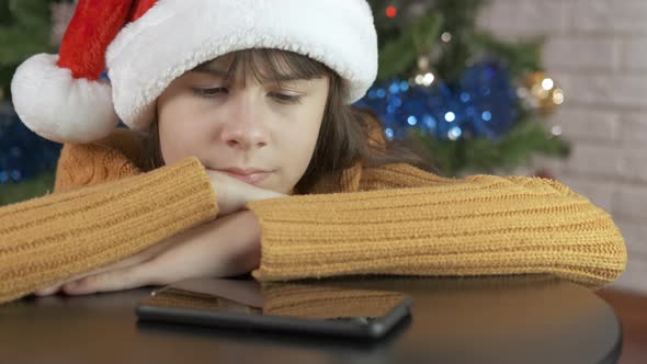 Teen wait for a call at Christmas.