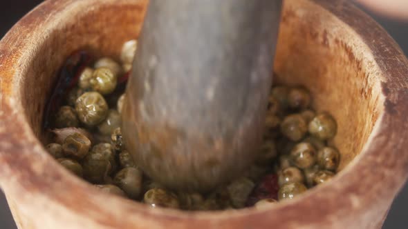 Using a Mortar and Pestle to Crush Chilies, Garlic and Green Peppercorns