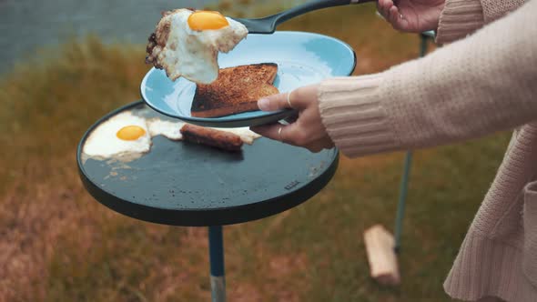Placing Eggs Baked On a Sheet Pan on toasted bread whilst camped by a lake