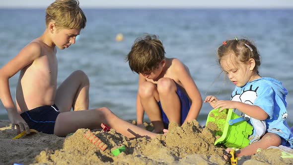 Three Kisd Playing on Sea Shore