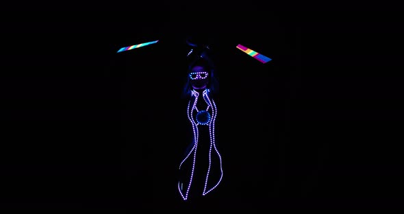 Woman Is Performing at the Nightclub Spinning LED Strips