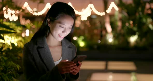 Young Business Woman Look at Smart Phone in City at Night