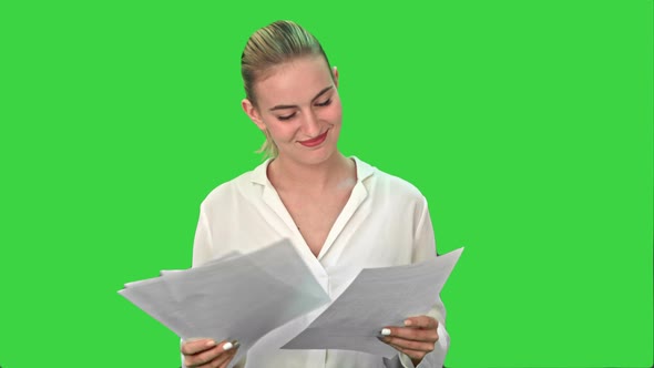 Happy Woman Finish Project and Throws Scraps of Paper on a Green Screen, Chroma Key