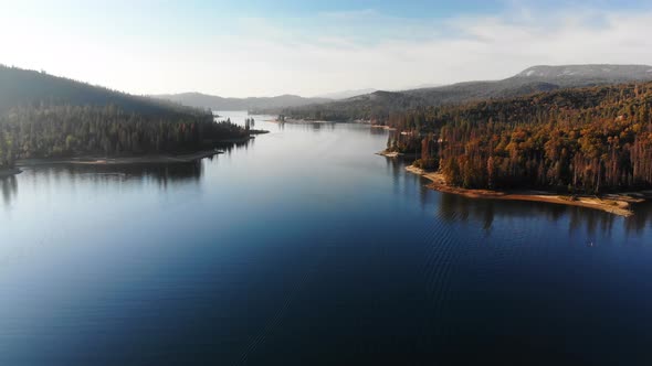 Aerial shot of beautiful blue alpine lake in late afternoon.