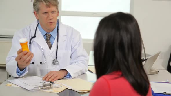 Doctor talks to patient and writes prescription