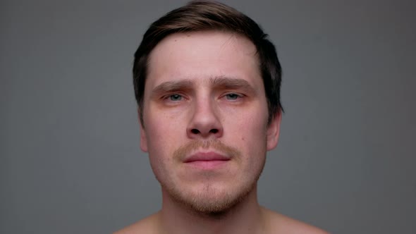 Handsome Man Looking Into Camera Isolated on Black Background