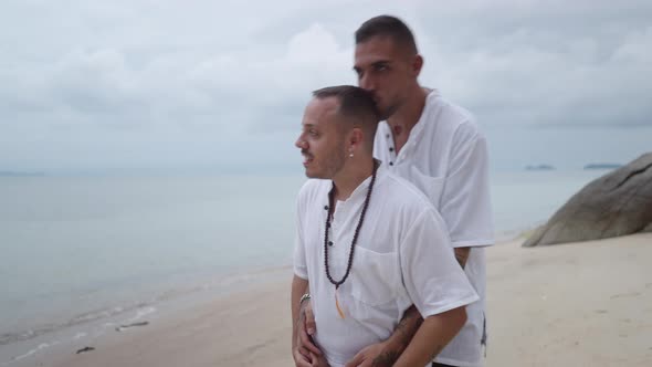 Embraced Gay Couple in 30Th Walking Along Tropical Beach and Kissing During Summer Vacation