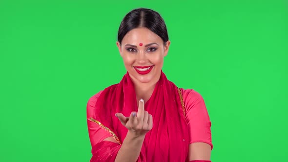 Portrait of a Young Indian Girl in National Classic Red Sari Is Looking Straight and Coquettishly