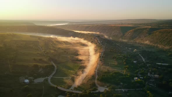 Aerial drone view of the Old Orhei at sunset. Valley with river and fog, village, monastery located 